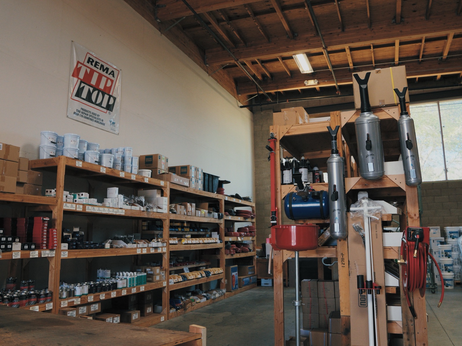 Rema Tip Top repair supplies and shop equipment on the warehouse floor