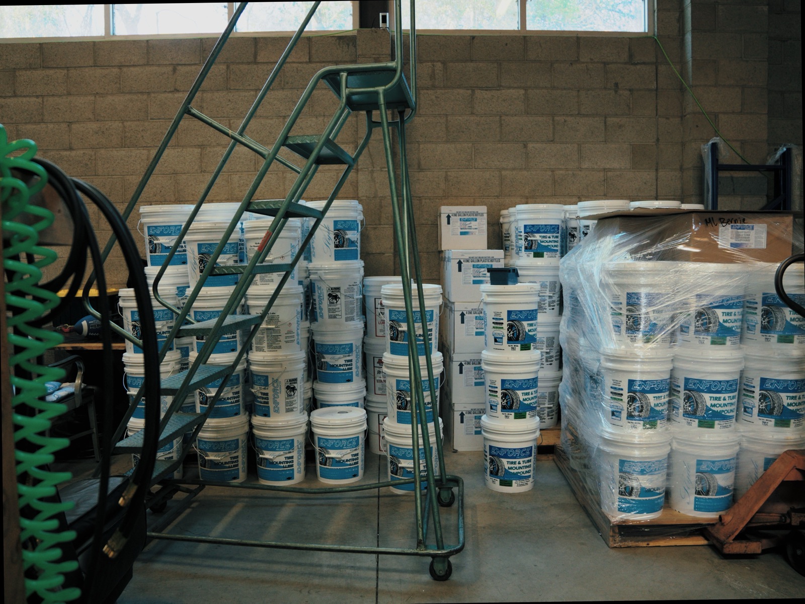 Pallets of tire lube buckets ready to ship