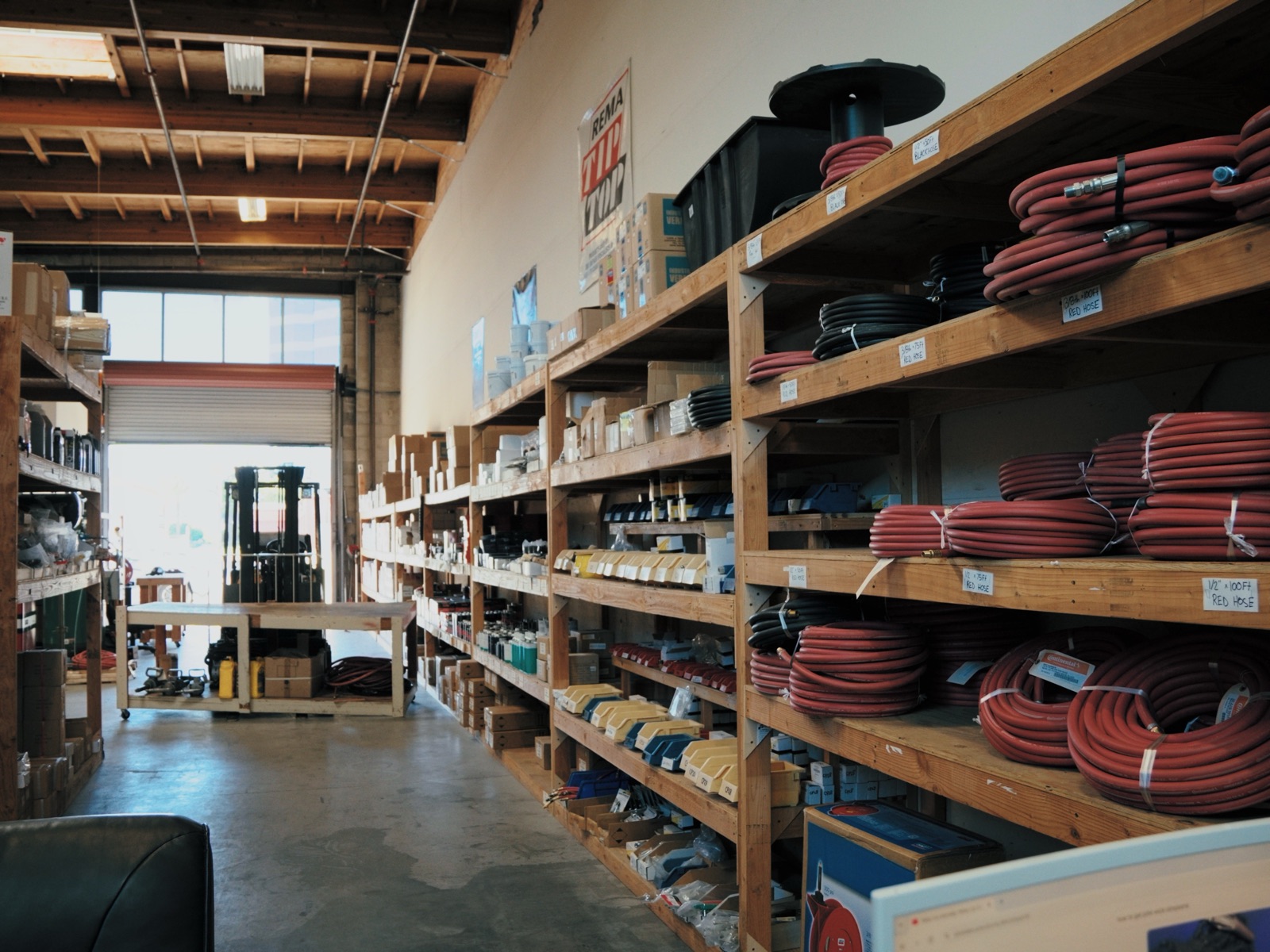 Aisle of air hoses and hose reels on warehouse shelving